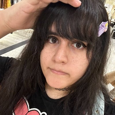 a woman with bangs in a black shirt