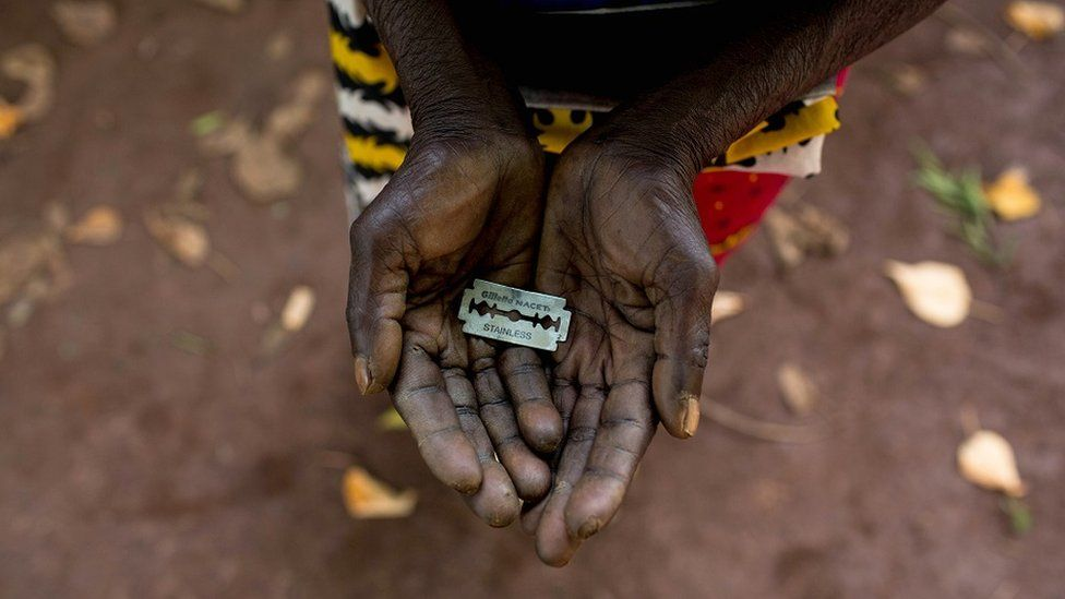 Female Genital Mutilation African Body Modification african woman holding a blade