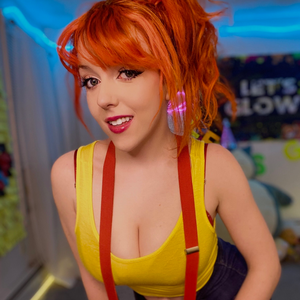 SpoopyKit @SpoopyKit, a hot tub streamer wearing yellow top with red hair.