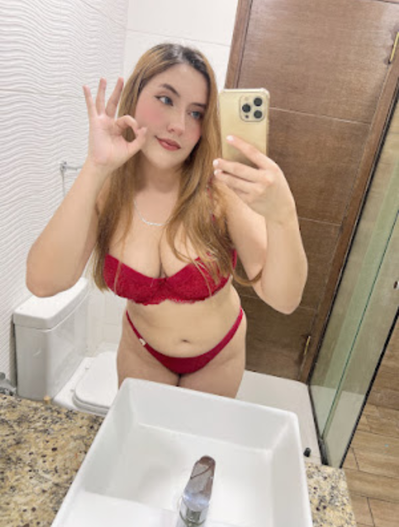 Peach Free OnlyFans account takes a picture in sexy red lingerie in front of a mirror 